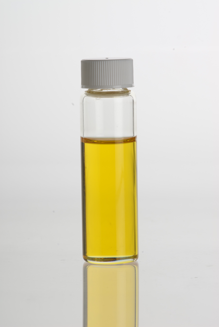 Photograph of a small glass vial filled about three quarters of the way up with orangey-yellow liquid.